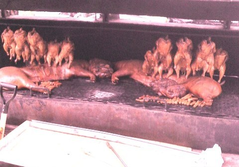Whole Chickens and Half Pigs on Grill