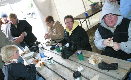 SMSU Tailgaters peeling New Orleans Style BBQ Shrimp