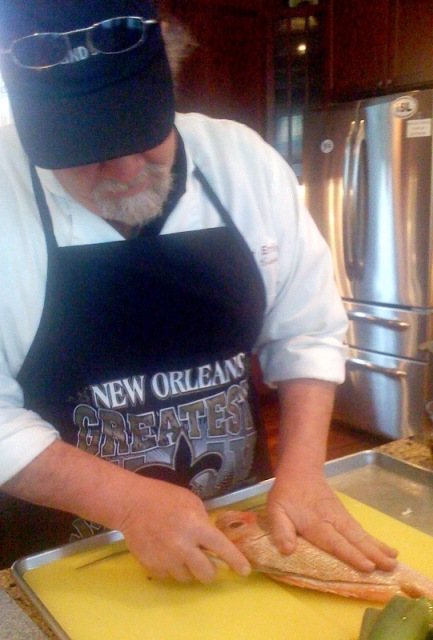 Chef Emile fillets a red snapper.